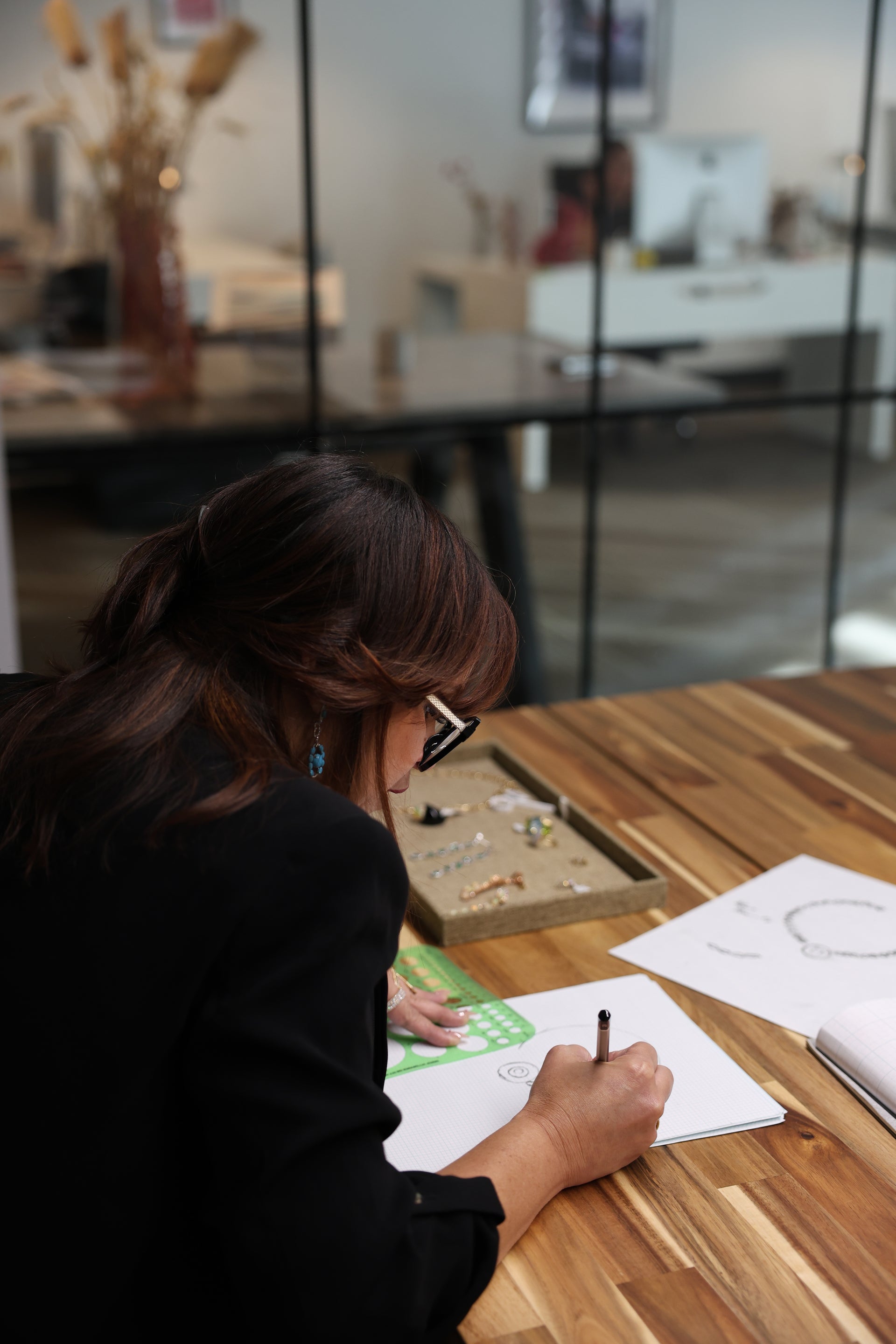 Koru specialist leaning over a counter during a private consultation