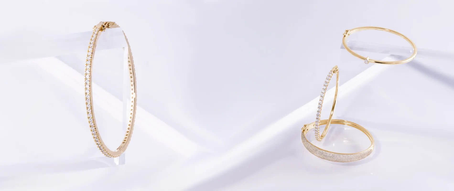 Set of elegant 14k gold bangles, showcasing intricate designs and shiny finishes, ideal for stylish accessories.