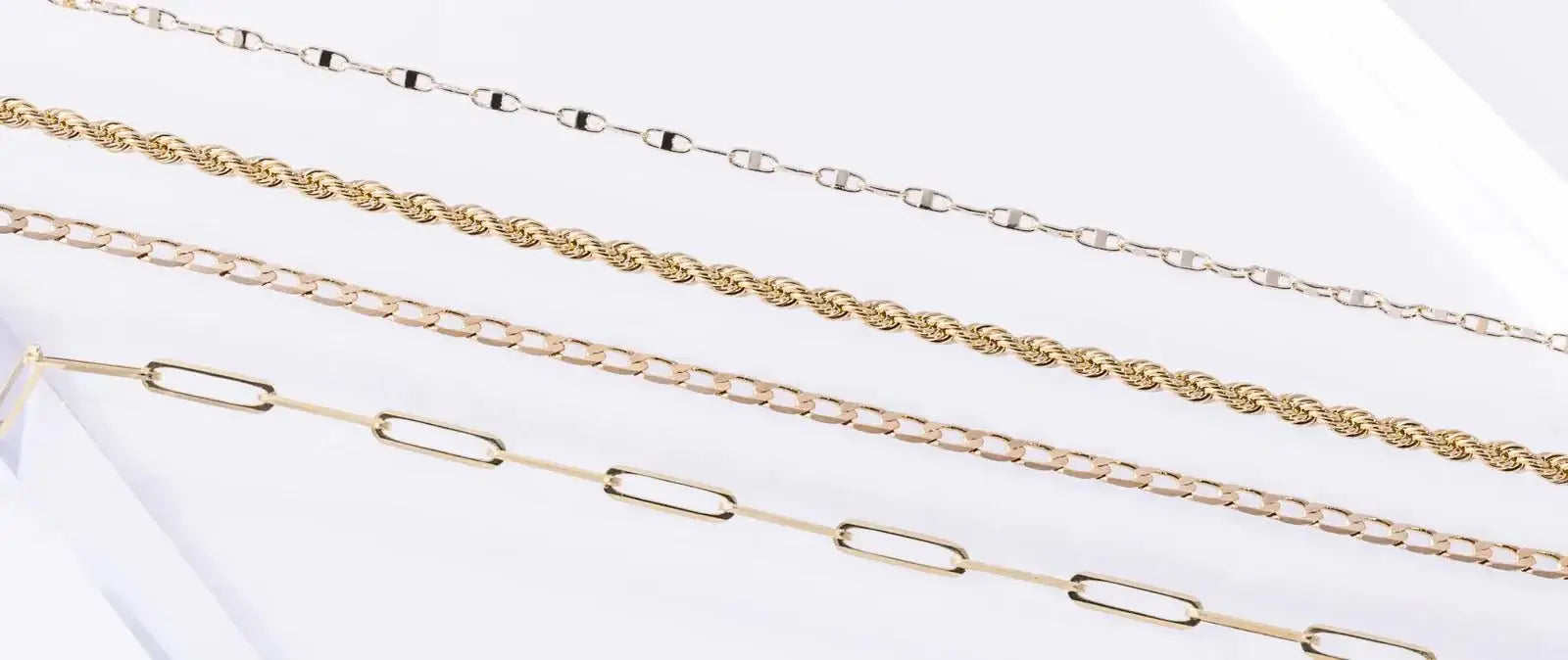 Various styles of gold chain including braided, link, and layered designs from Koru Jewelers.