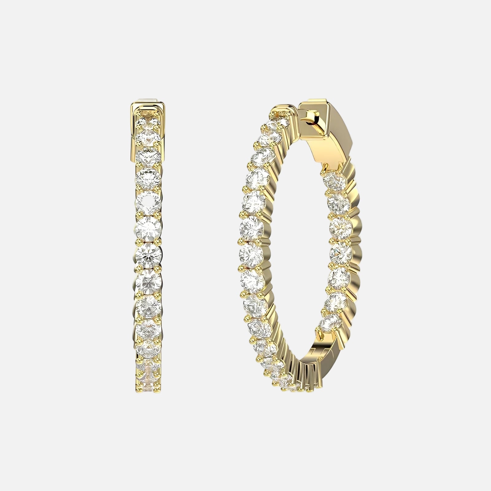 Gold hoop earrings with clear gemstones on a light gray background