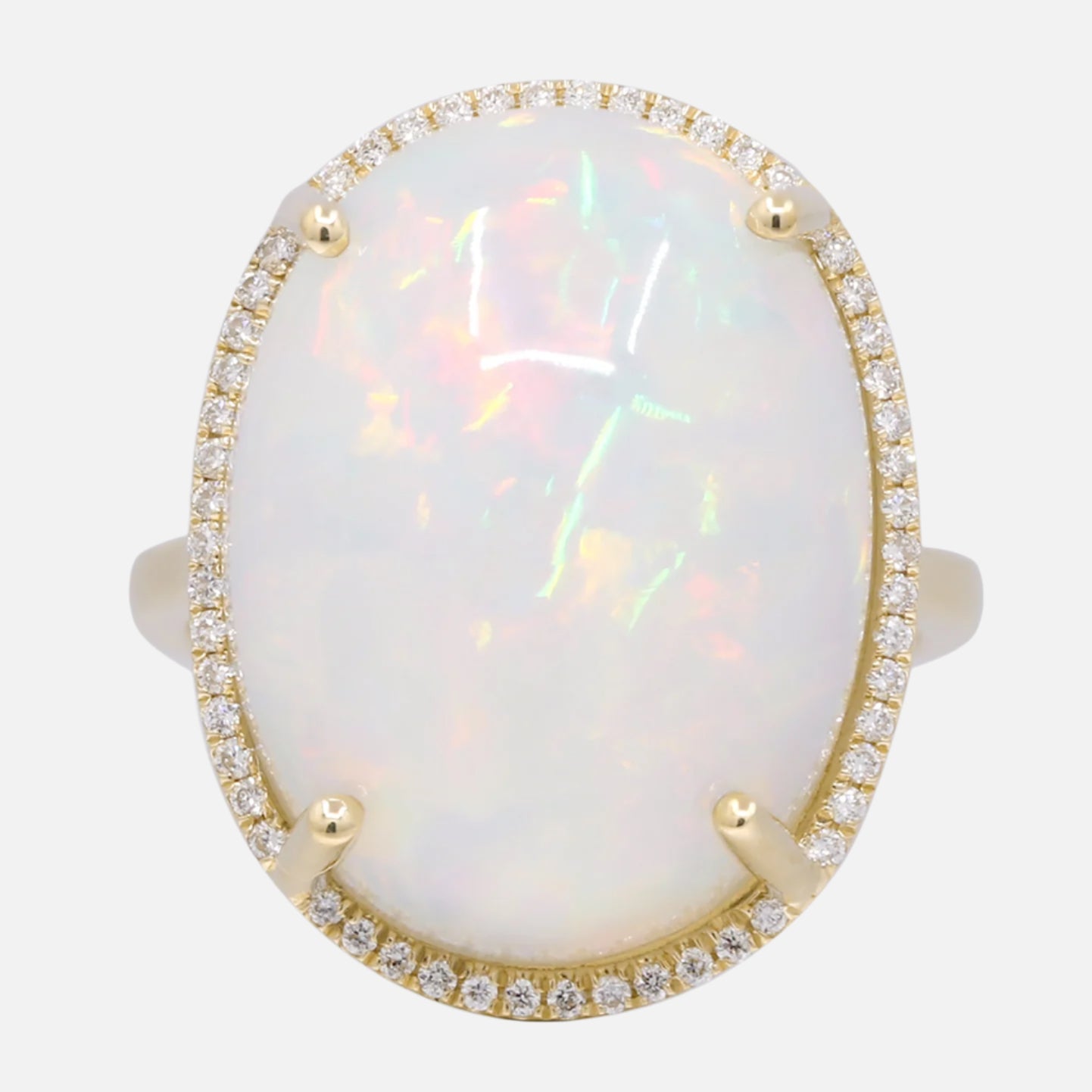 Ring with natural opal stone and a gold border with diamonds
