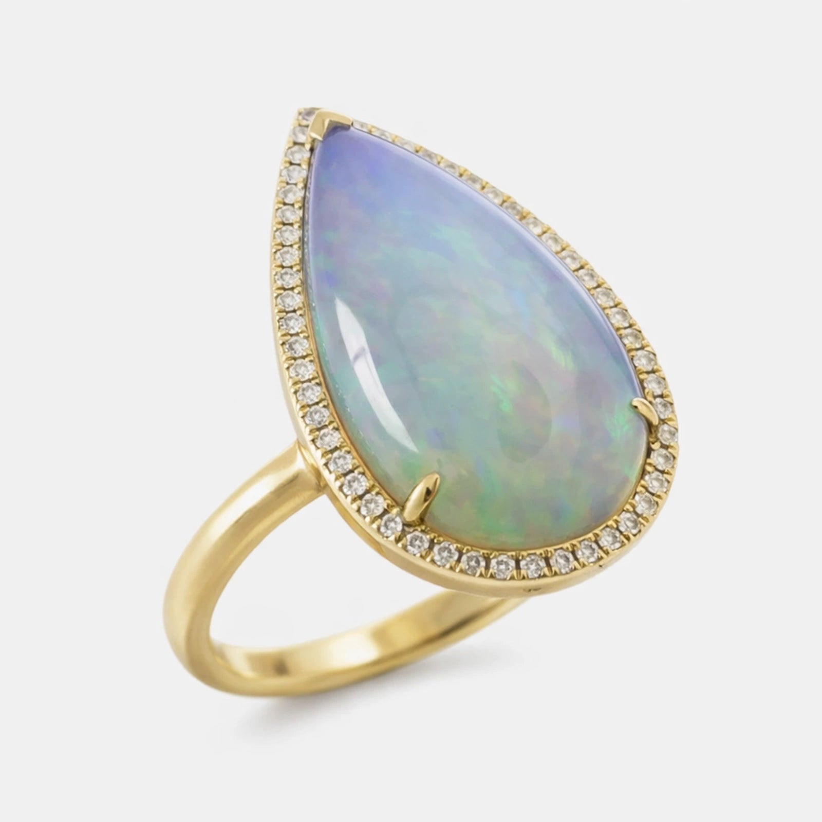 Gold ring with a large teardrop-shaped opal stone on a white background