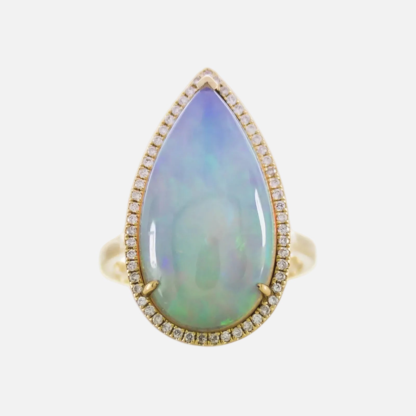 Ring with a teardrop-shaped opal stone and gold border on a white background