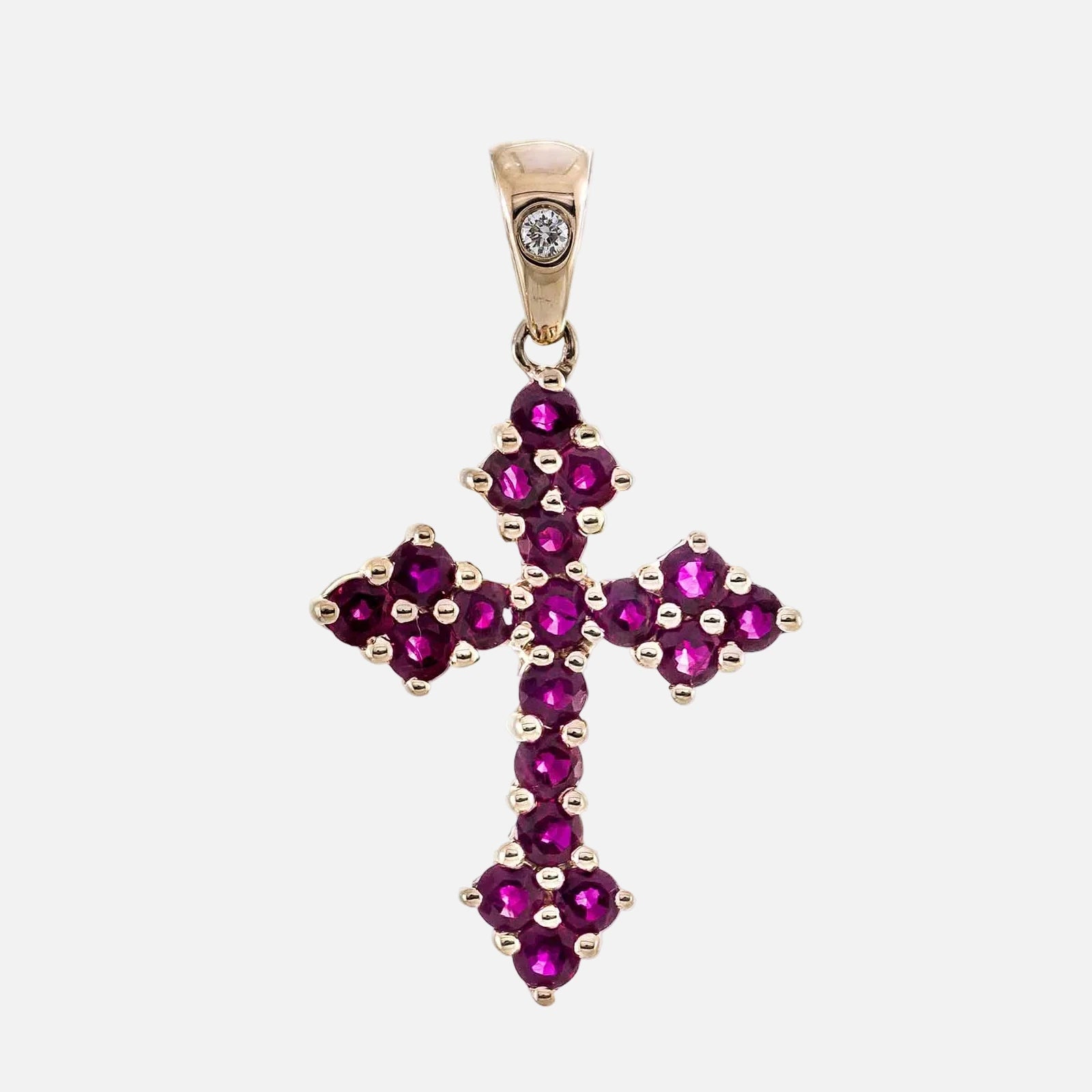 10K Rose Gold Ruby Cross Pendant with Diamond Accent showcasing vibrant rubies and a diamond detail.