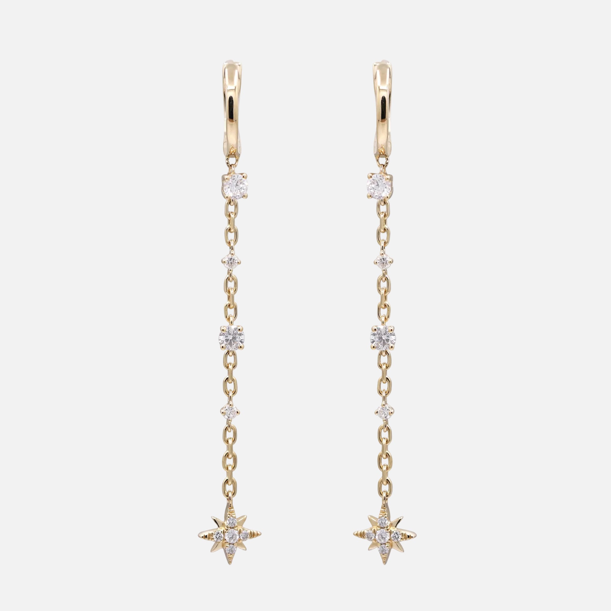 Diamond Star Drop Earrings featuring gold huggies and shimmering diamond accents in a playful design.