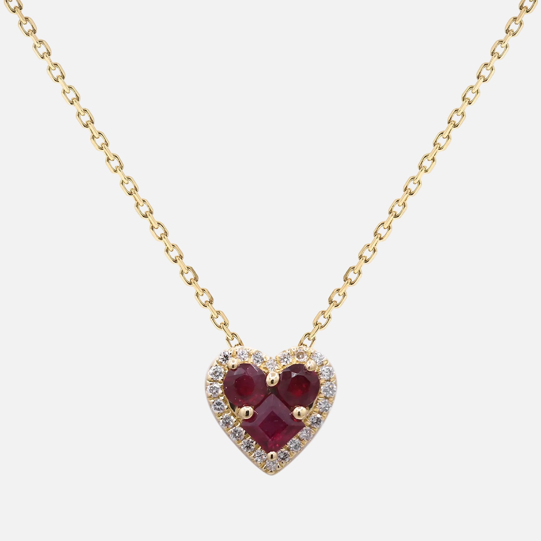 Ruby Heart Pendant with Diamond Halo in 14K yellow gold, featuring red rubies and a diamond halo, perfect for a romantic gift.