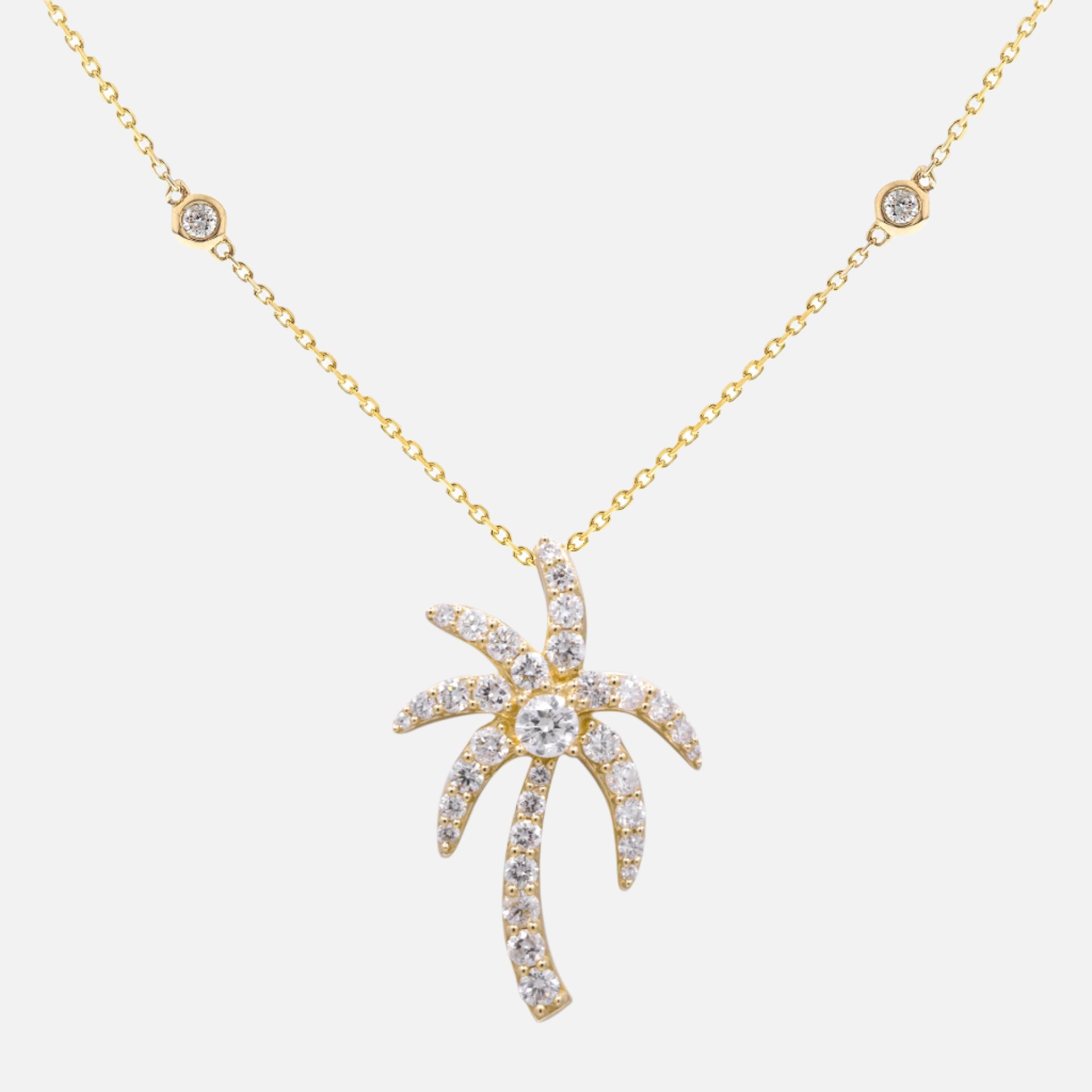 Gold necklace with a palm tree diamond pendant
