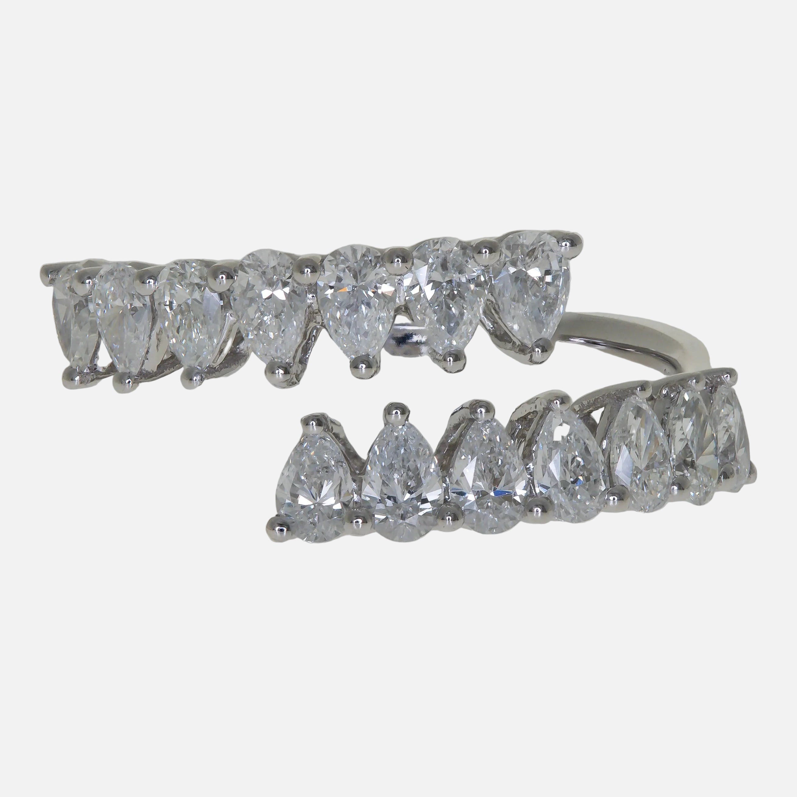 Pear Cut Diamond Ring featuring an open band design with sparkling pear-shaped diamonds in 18K white gold.