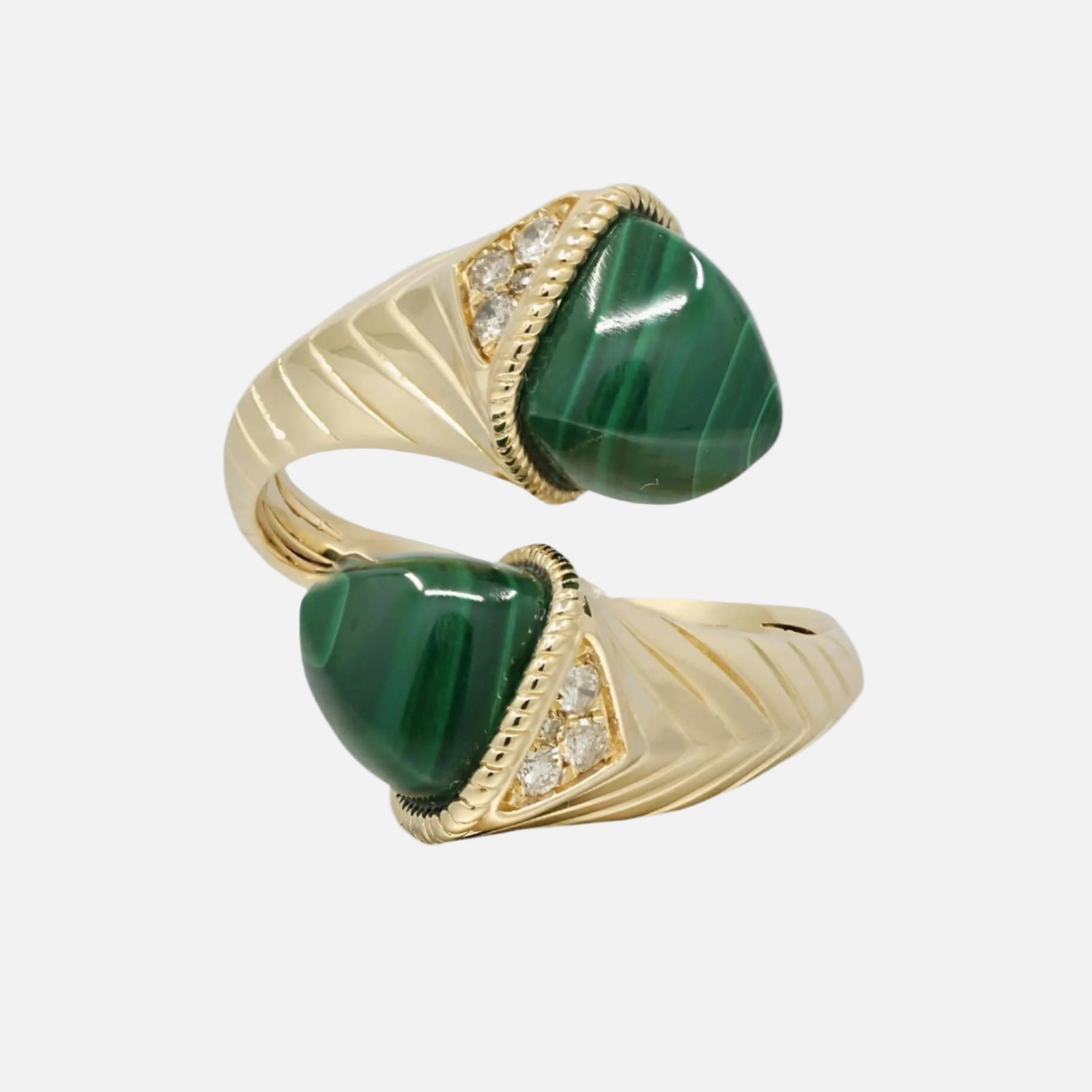 Pair of gold rings with green stones on a white background