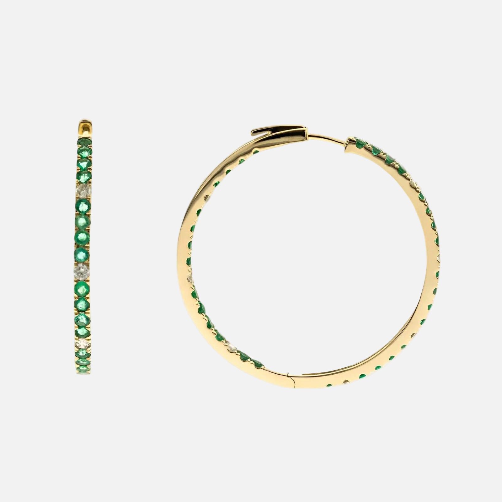 Gold hoop earrings with green gemstones on a white background