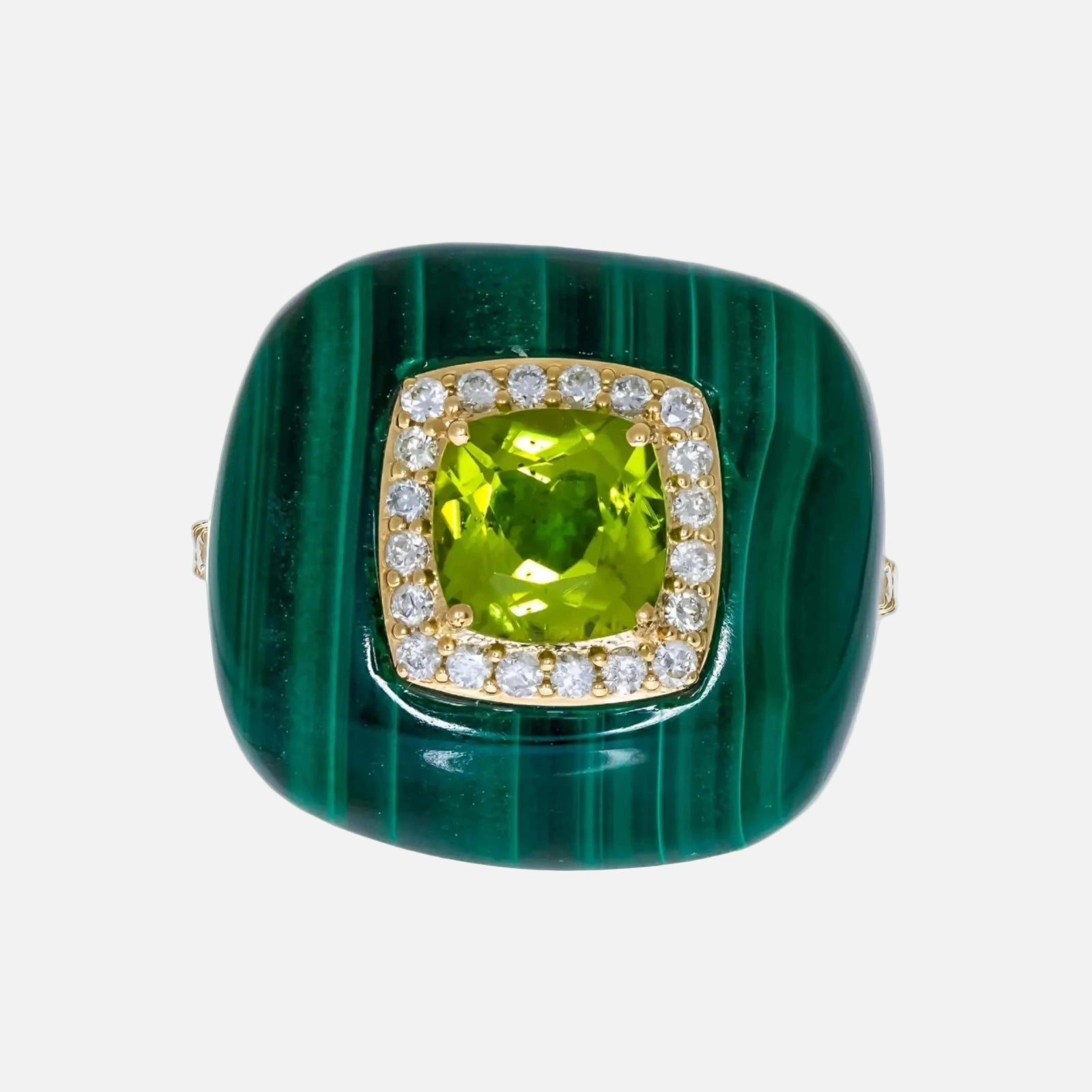 Green stone ring with gold and diamond accents on a white background